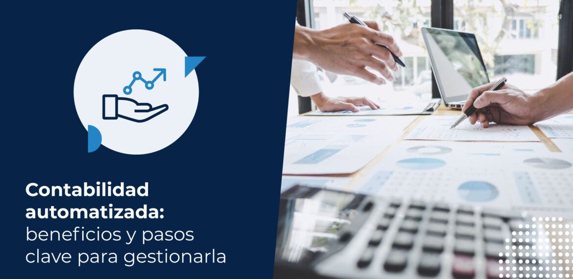 Dos personas de negocios están sentadas en un escritorio, analizando documentos con gráficos y un computador. Se encuentran trabajando en la contabilidad automatizada de su empresa.