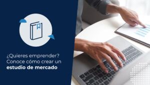 Persona analizando gráficos financieros y utilizando un computador sobre un escritorio blanco, ilustrando los pasos sobre cómo crear un estudio de mercado profesional.